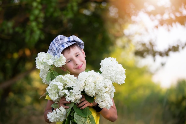 Cheerful happy village child with a bouquet of flowers