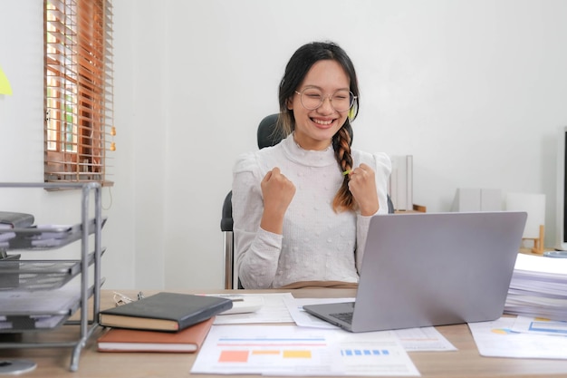 Cheerful lady working on laptop in home and use a computer laptop and thinking idea for her business