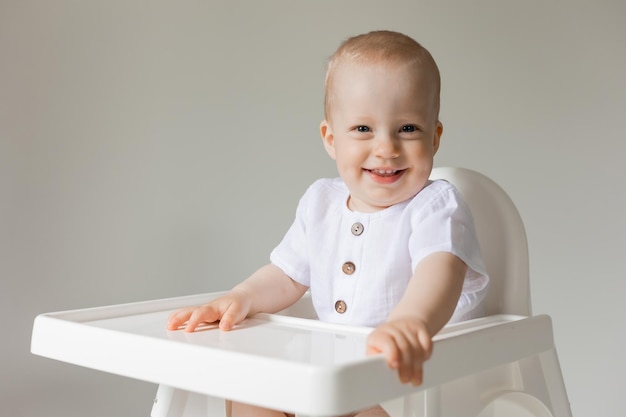 cheerful little boy in high chair, health, space for text, banner, card