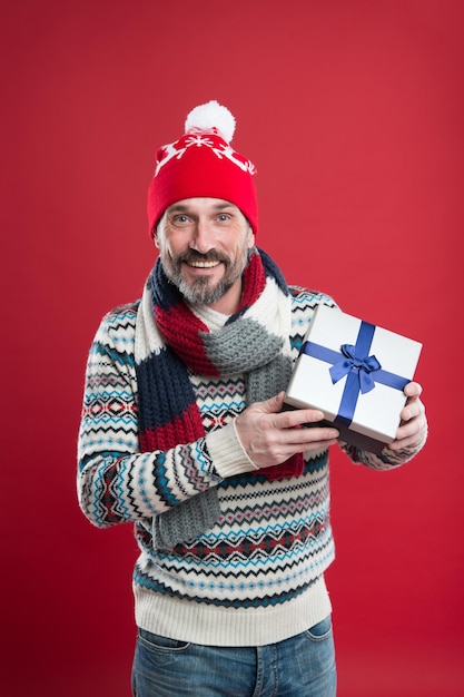 Cheerful man congratulate with xmas buy new year presents and gifts winter holiday surprise mature man warm knitted clothes and accessory male fashion for cold winter merry christmas