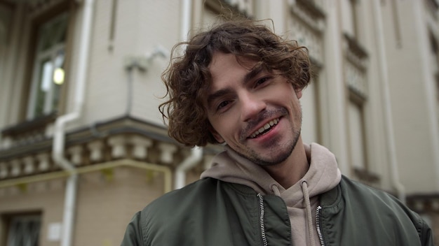 Cheerful man feeling happy outdoor closeup joyful guy enjoying city center