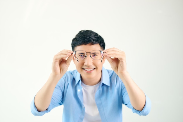 Cheerful man holding glasses in front of him on a white background