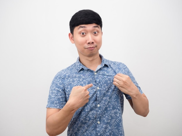 Cheerful man point finger at his blue shirt portrait