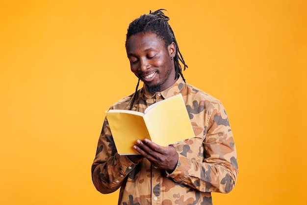 Cheerful man reading fiction book