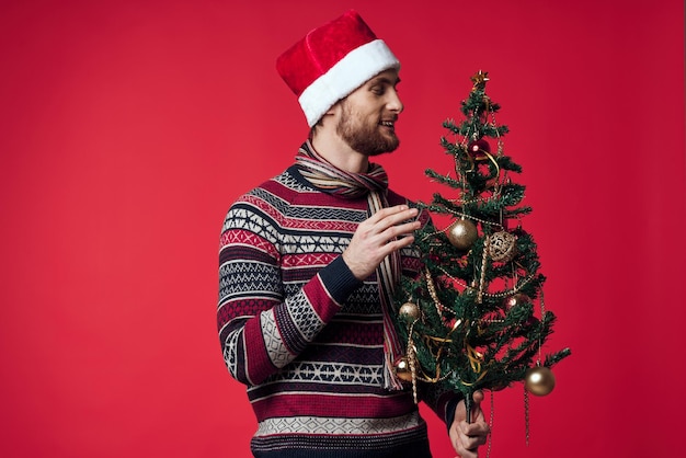 Cheerful man in a santa hat Christmas decorations holiday New Year studio posing High quality photo