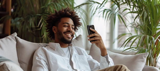 Cheerful man using cellphone at residence with blank area for writing