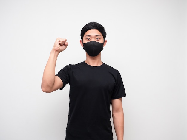 Cheerful man wearing protect mask show one fist up on white background