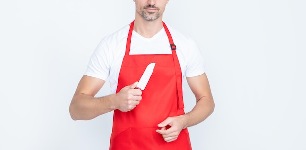 Cheerful mature man cook in apron with knife on white background