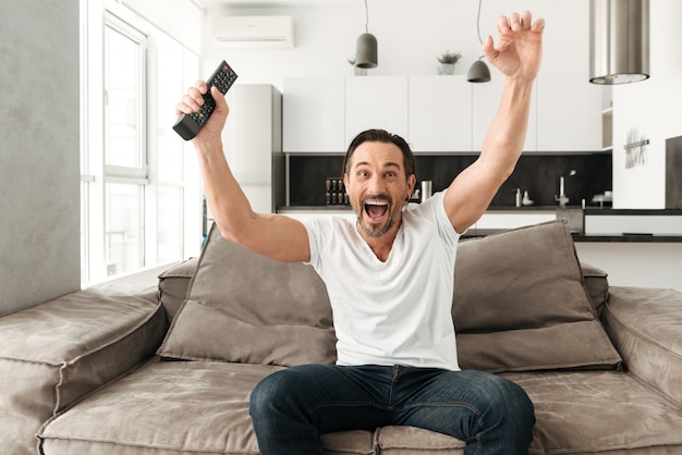 Cheerful mature man sitting on a sofa