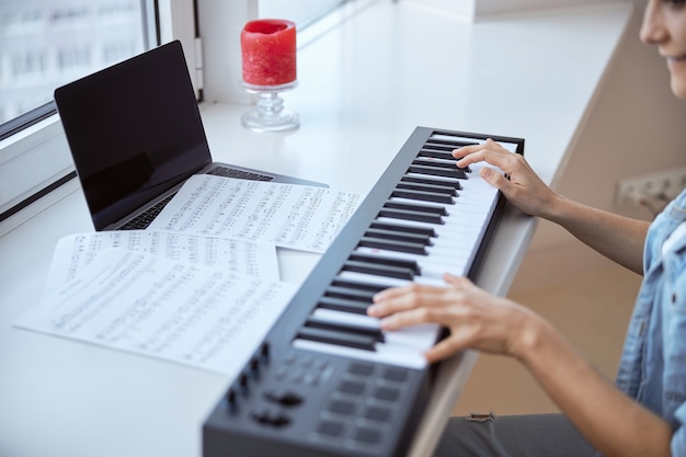 Cheerful musician expressing positivity while learning new melody from notes