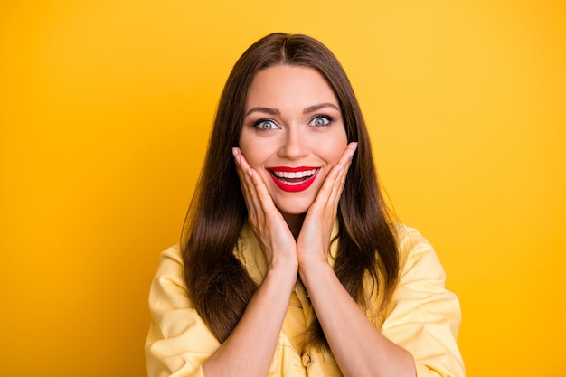 cheerful overjoyed crazy excited woman  with admiration smile toothy isolated vivid yellow color wall