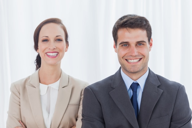 Cheerful partners posing together looking at camera