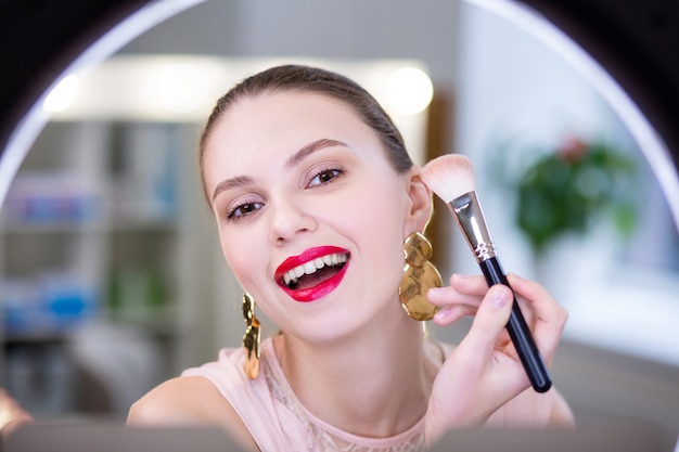 Cheerful positive woman being ready to go while having beautiful makeup