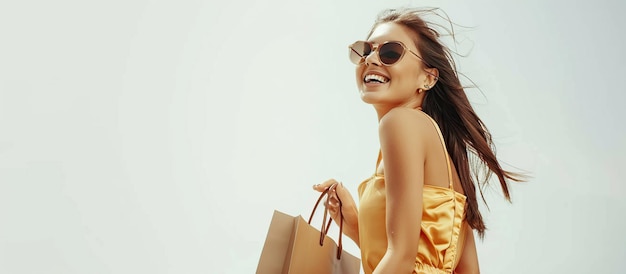 Cheerful smiling teenage woman enjoying shopping she carries shopping bags on white background