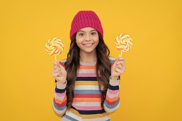 Cheerful teen girl with lollipop candy dental care