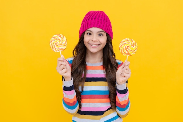 Cheerful teen girl with lollipop candy dental care