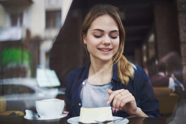 Cheerful woman cup of coffee cake lifestyle leisure