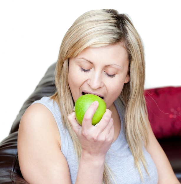 Cheerful woman eating an apple