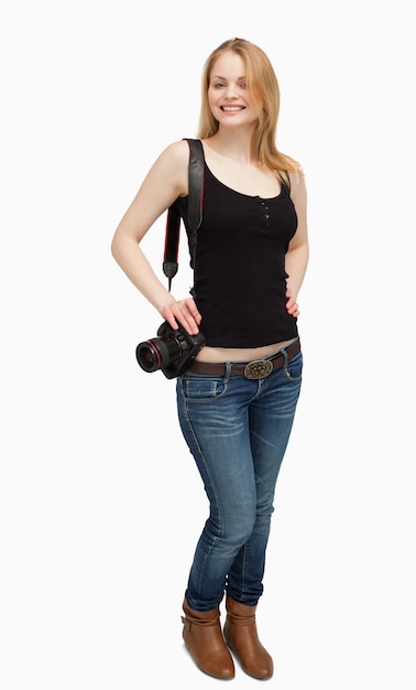 Cheerful woman holding a camera