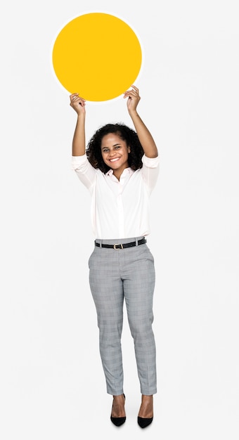 Cheerful woman holding a round yellow board