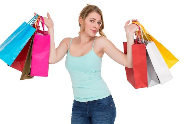 Cheerful woman holding shopping bags