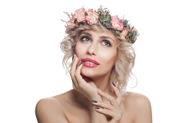 Cheerful woman with makeup and flowers Pretty model with looking up and smiling