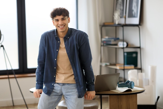 Cheerful Young Businessman Posing Smiling To Camera Sitting In Office