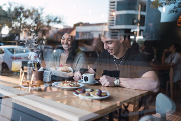 Cheerful young couple on a romantic date in a cafe.