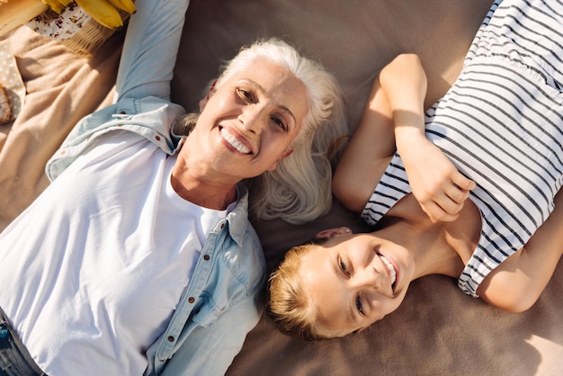 Cheerful young girl spending time with her grandmother