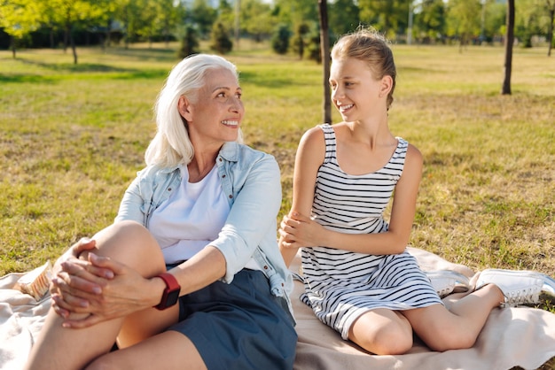 Cheerful young girl spending time with her grandmother