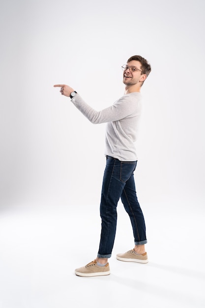 Cheerful young man wearing casual clothes isolated over white background