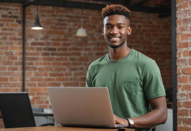 A cheerful young man works on a laptop in a brickwalled office space his smile and relaxed posture