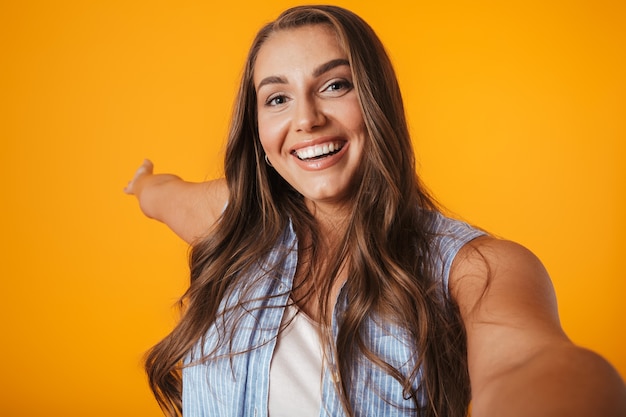 Cheerful young overweight woman, taking a selfie