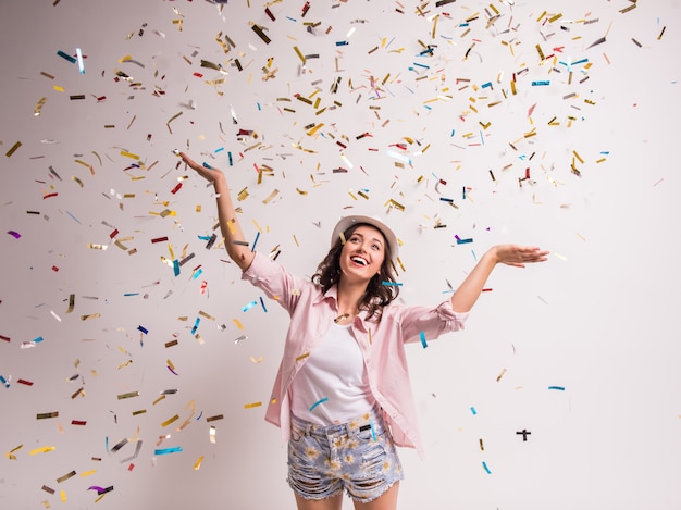 Cheerful young woman is stretching out her hands.