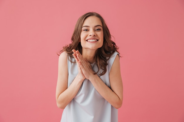 Cheerful young woman standing isolated