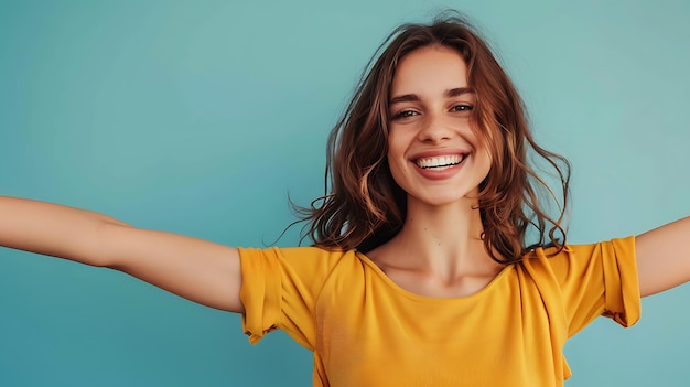 Cheerful young woman with bright smile showing copy space in blue background