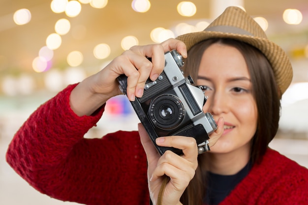 Cheerful young woman with camera