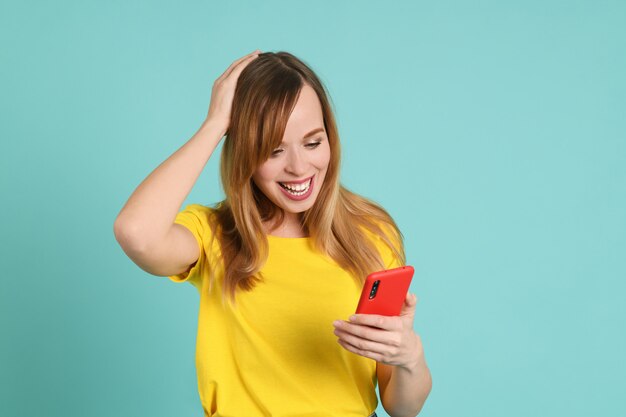 Cheerful young woman with smartphone