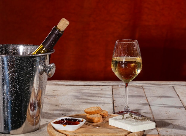 Cheese board served with marmalade and fresh white wine