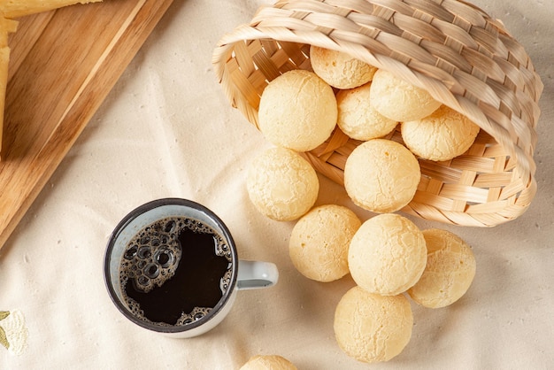 Cheese bread, breakfast table in Brazil, cheese bread, coffee and accessories, selective focus.