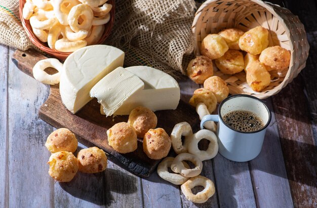 Cheese bread and more cheese bread manioc flour cookies and Minas cheese arranged on a rustic wooden surface with accessories selective focus