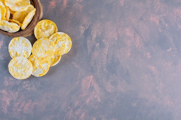 Cheese chips in a bowl on the marble surface