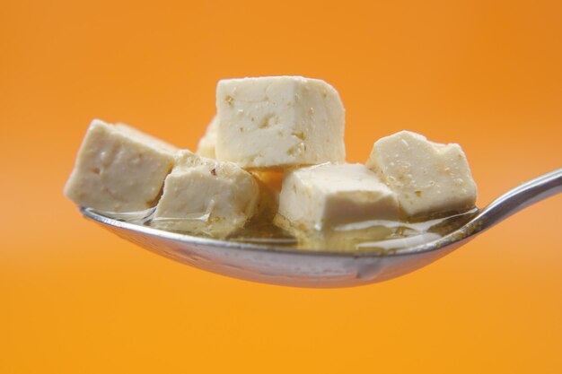 Cheese cube on a spoon close up