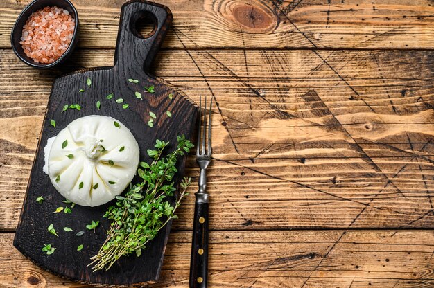 Cheese mozzarella on a wooden cutting board