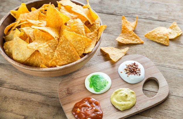 Cheese nachos with different types of sauce