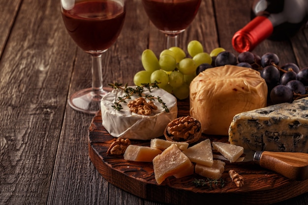 Cheese, nuts, grapes and red wine 