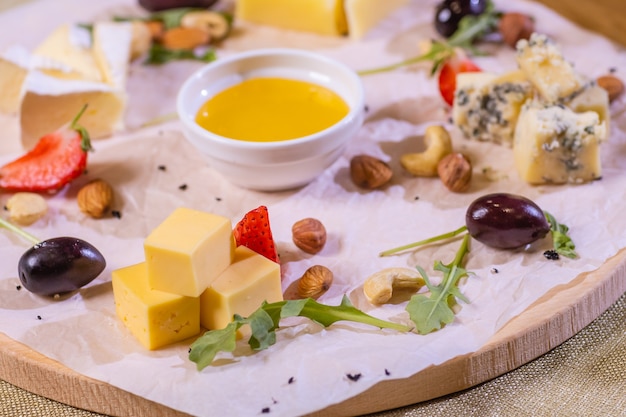 Cheese plate with cheeses dorblu parmesan brie camembert and roquefort in serving on the table from ...