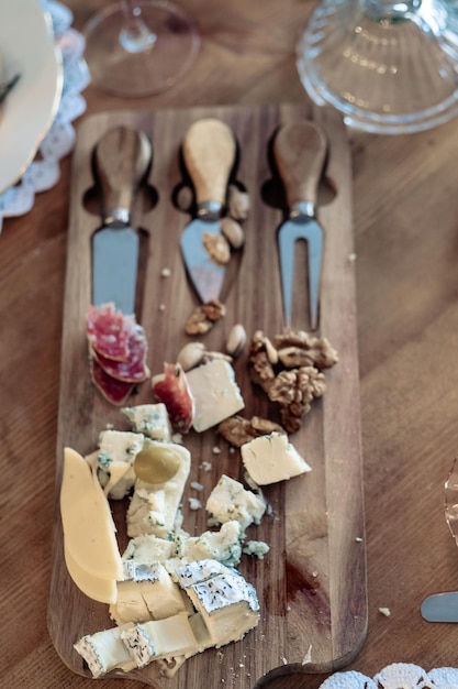 Cheese plate with different types with walnuts and tasting devices top view