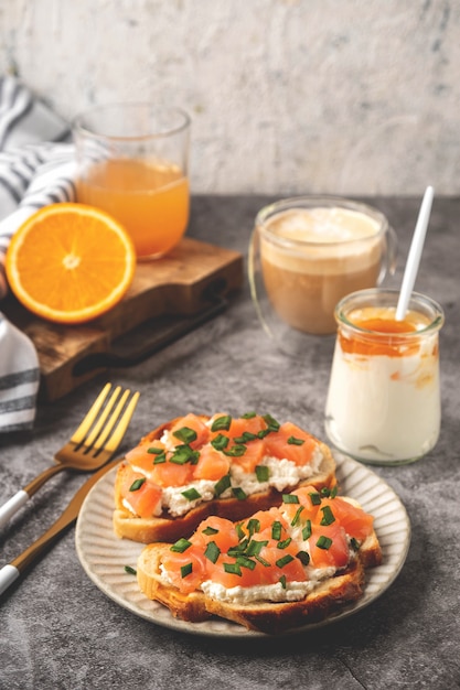 Cheese and salmon toasts, breakfast concept with coffee and freshly squeezed orange juice, healthy food.