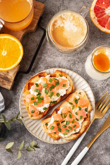 Cheese and salmon toasts, breakfast concept with coffee and freshly squeezed orange juice, healthy food.